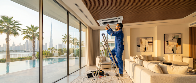 AC technician servicing a wall mounted air conditioner
